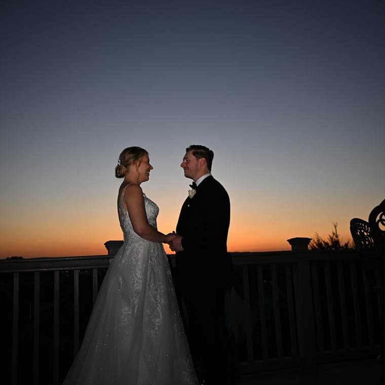 A couple at sunset on the overlook at The One & Only Westmount Country Club