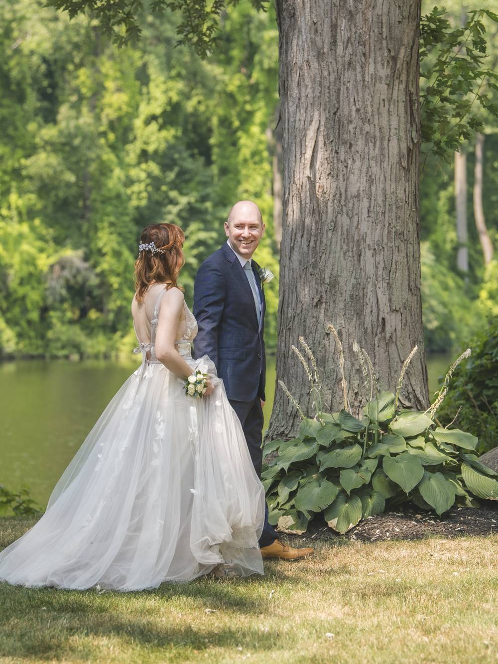 A couple beneath a century-old silver maple at River Stone Manor